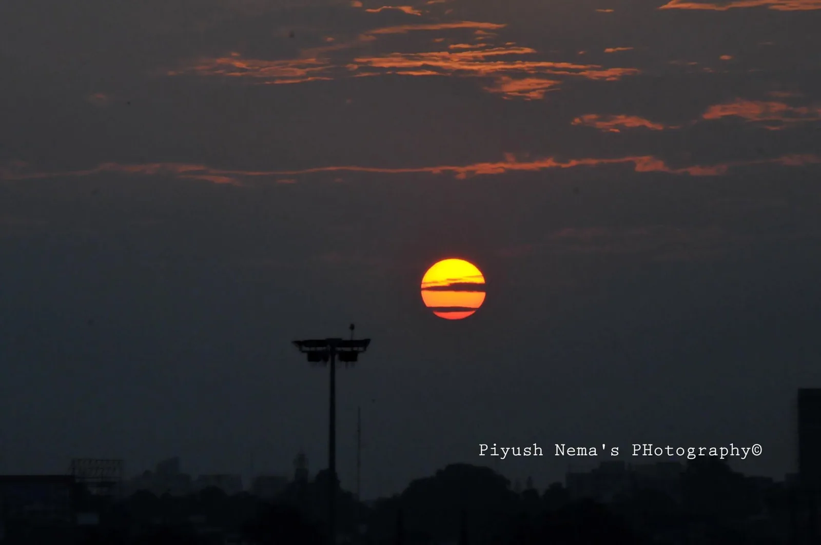 Sunset behind the water tower — photography by Nemora